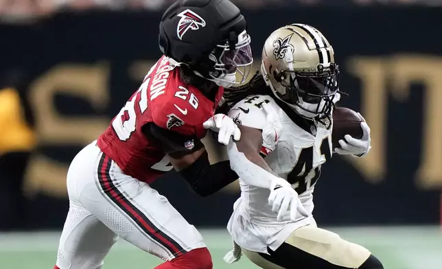 New Orleans Saints running back Alvin Kamara (41) runs against Atlanta Falcons cornerback C.J. Henderson (26) during the second half of an NFL football game in New Orleans, Monday, Oct. 5, 2026. (AP Photo/Gerald Herbert)