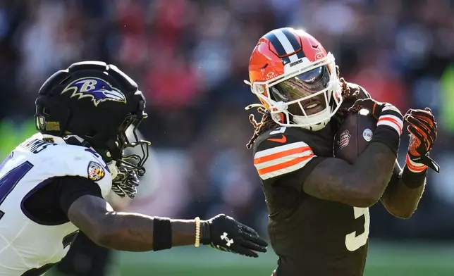 Cleveland Browns wide receiver Jerry Jeudy, right, runs the ball past Baltimore Ravens safety Malaki Starks during the second half of an NFL football game in Cleveland, Sunday, Oct. 18, 2026. (AP Photo/Sue Ogrocki)