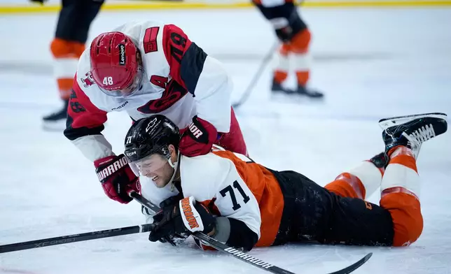 Carolina Hurricanes' Jordan Martinook, left, punches Philadelphia Flyers' Tyson Foerster during the second period of an NHL hockey game Sunday, Oct. 11, 2026, in Philadelphia. (AP Photo/Matt Slocum)