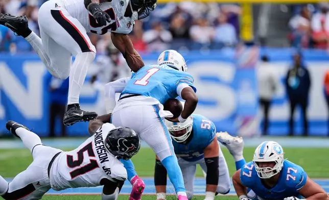 Tennessee Titans quarterback Cam Ward (1) is sacked by Houston Texans defensive end Will Anderson Jr. (51) with help from defensive end Danielle Hunter (55) as guard Peter Skoronski (77) and Austin Schlottmann (51) look on during the second half of an NFL football game in Nashville, Tenn., Sunday, Oct. 11, 2026. (AP Photo/George Walker IV)