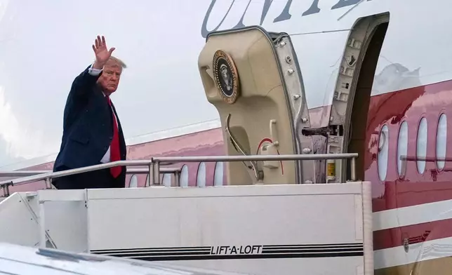 President Donald Trump waves as he boards Air Force One, Sunday, Oct. 25, 2026, at Selfridge Air National Guard Base, Mich. (AP Photo/Julia Demaree Nikhinson)