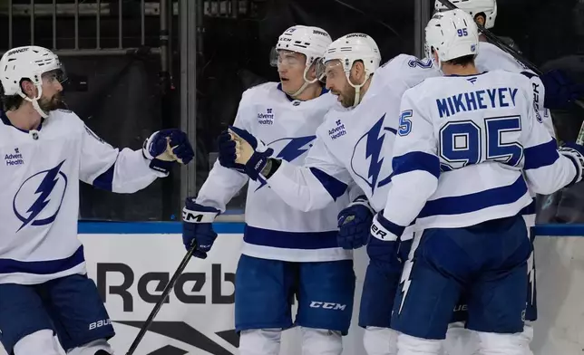 Tampa Bay Lightning's Zemgus Girgensons, center right, celebrates with teammates after scoring during the first period of an NHL hockey game against the New York Rangers in New York, Tuesday, Oct. 13, 2026. (AP Photo/Seth Wenig)