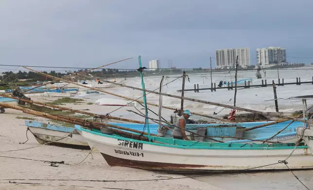Mexican fishermen inspect their boats as Hurricane Isaias passes through the Gulf of Mexico, north of Progreso, Yucatan state, Mexico, Thursday, Oct. 8, 2026. (AP Photo/Martin Zetina)