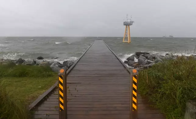 High waves generated by the effects of Isaias crash onto the empty beach on Friday, Oct. 9, 2026, in Dauphin Island, Ala. (AP Photo/Octavio Jones)