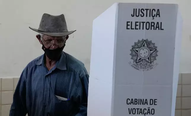 A man votes in the presidential runoff in Brasilia, Brazil, Sunday, Oct. 25, 2026. (AP Photo/Eraldo Peres)