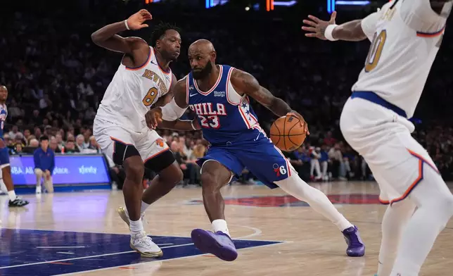 Philadelphia 76ers forward LeBron James (23) drives against New York Knicks forward Og Anunoby during the second half of an NBA basketball game Tuesday, Oct. 20, 2026, in New York. (AP Photo/Frank Franklin II)
