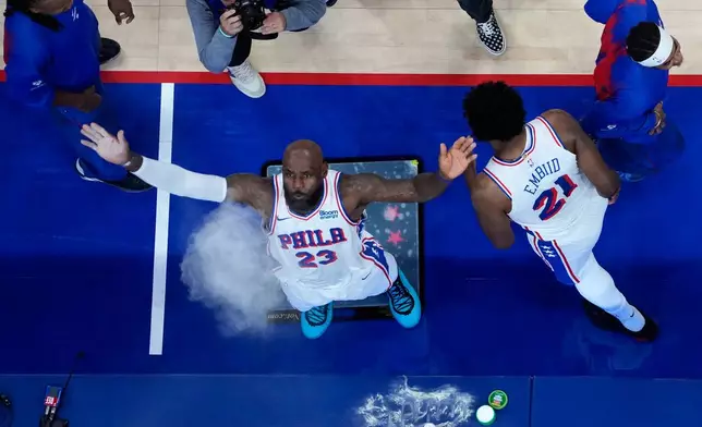 Philadelphia 76ers' LeBron James throws chalk in the air before a preseason NBA basketball game against the Boston Celtics Friday, Oct. 16, 2026, in Philadelphia. (AP Photo/Matt Slocum)