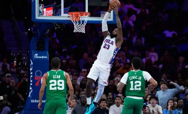 Philadelphia 76ers' LeBron James goes up for a dunk during the first half of a preseason NBA basketball game against the Boston Celtics Friday, Oct. 16, 2026, in Philadelphia. (AP Photo/Matt Slocum)