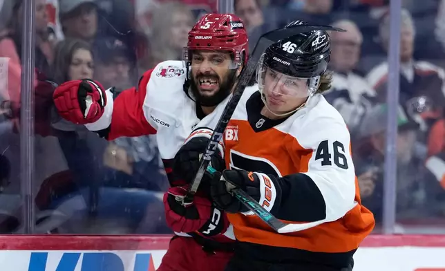 Philadelphia Flyers' Trevor Zegras, right, and Carolina Hurricanes' Jalen Chatfield collide during the second period of an NHL hockey game Sunday, Oct. 11, 2026, in Philadelphia. (AP Photo/Matt Slocum)