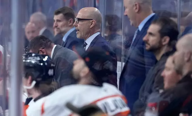 Philadelphia Flyers' Rick Tocchet coaches during the third period of an NHL hockey game against the Carolina Hurricanes Sunday, Oct. 11, 2026, in Philadelphia. (AP Photo/Matt Slocum)