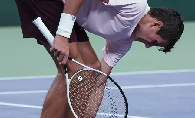 Spain's Rafael Jodar checks his foot during the men's singles final against Spain's Alejandro Davidovich Fokina at the Shanghai Masters tennis tournament in Shanghai, China, Sunday, Oct. 18, 2026. (AP Photo/Andy Wong)