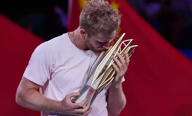 Spain's Alejandro Davidovich Fokina kisses the championship trophy after winning the men's singles final against Spain's Rafael Jodar at the Shanghai Masters tennis tournament in Shanghai, China, Sunday, Oct. 18, 2026. (AP Photo/Andy Wong)