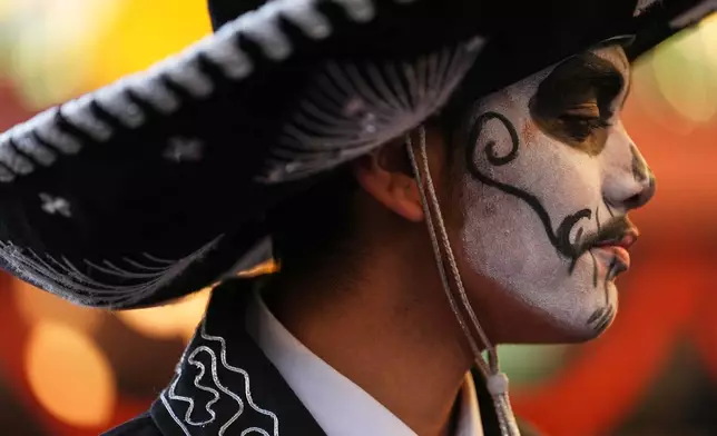 Junior Santana of Mexican youth folklore dance group Santana Charro Bros. looks on during a Día de Muertos celebration at Pike Place Market, Friday, Oct. 23, 2026, in Seattle. (AP Photo/Lindsey Wasson)