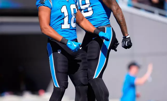 Carolina Panthers' Darren Waller (88) celebrates with teammates Jalen Coker (18) after scoring a touchdown during the first half of an NFL football game against the Tampa Bay Buccaneers in Charlotte, N.C., Sunday, Oct. 25, 2026. (AP Photo/Erik Verduzco)
