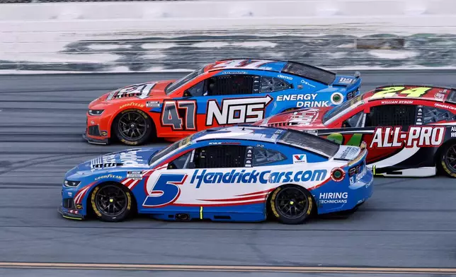 Kyle Larson (5) passes Ricky Stenhouse Jr. (47) for the win in a NASCAR Cup Series auto race, Sunday, Oct. 25, 2026, in Talladega, Ala. (AP Photo/Butch Dill)
