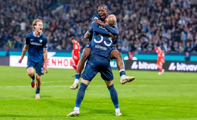 Bochum's Philipp Hofmann, back to the camera, celebrates with Mansour Ouro-Tagba after scoring his side's second goal during the German soccer cup match between VfL Bochum and FSV Mainz 05 in Bochum, Germany, Tuesday, Oct. 27, 2026. (David Inderlied/dpa via AP)
