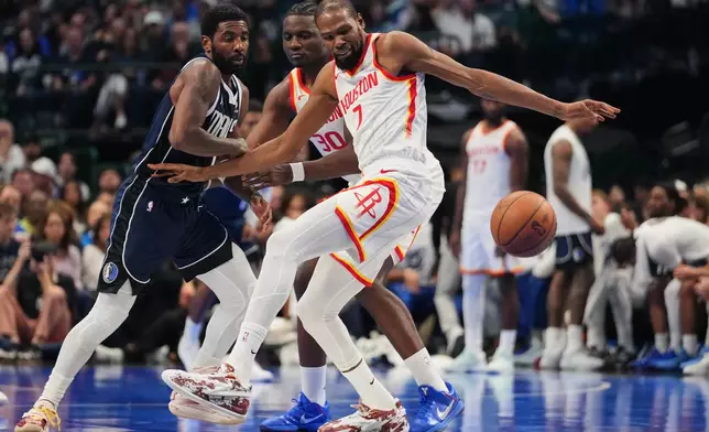 Dallas Mavericks guard Kyrie Irving (11) knocks the ball away from Houston Rockets forward Kevin Durant (7) during the first half of an NBA Cup basketball game in Dallas, Friday, Oct. 30, 2026. (AP Photo/Tony Gutierrez)
