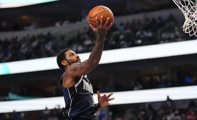 Dallas Mavericks guard Kyrie Irving leaps to the basket to take a shot during the first half of an NBA Cup basketball game against the Houston Rockets in Dallas, Friday, Oct. 30, 2026. (AP Photo/Tony Gutierrez)