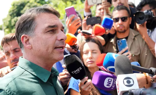 Opposition presidential candidate Sen. Flavio Bolsonaro speaks to the press after visiting his father, former President Jair Bolsonaro who is serving his sentence for a coup attempt at home, in Brasilia, Brazil, Tuesday, Oct. 13, 2026. (AP Photo/Eraldo Peres)