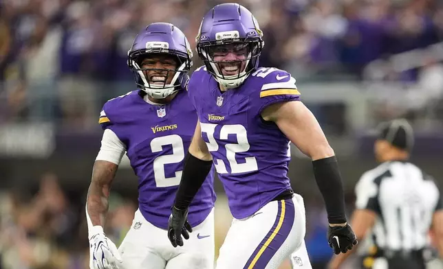 Minnesota Vikings safety Harrison Smith (22) celebrates with cornerback Isaiah Rodgers (2) after intercepting a pass against the Indianapolis Colts during the second half of an NFL football game in Minneapolis, Sunday, Oct. 25, 2026. (AP Photo/Ellen Schmidt)