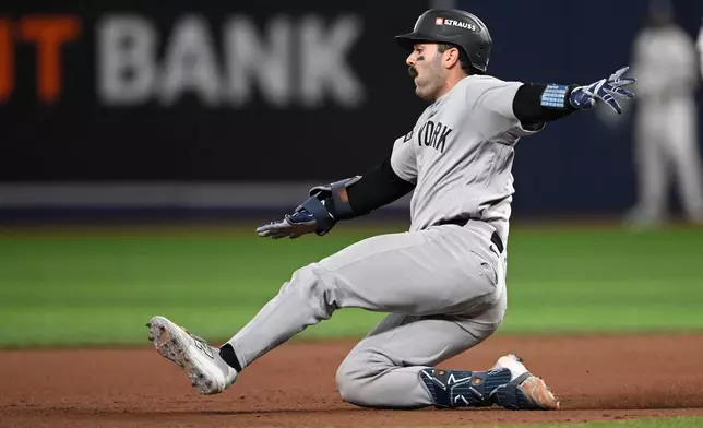 New York Yankees' Austin Wells slides into second for a double during the fifth inning in Game 2 of an American League Division Series baseball game against the Tampa Bay Rays Monday, Oct. 5, 2026, in St. Petersburg, Fla. (AP Photo/Phelan Ebenhack)