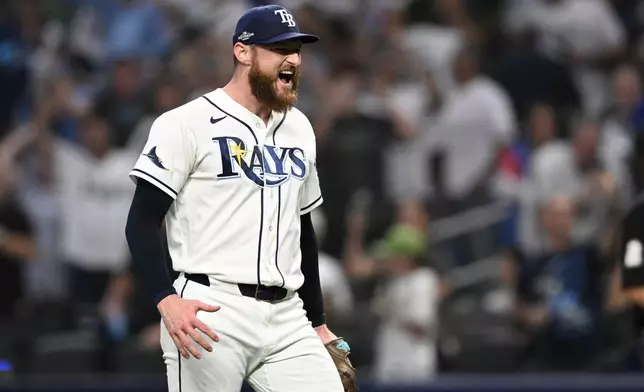 Tampa Bay Rays pitcher Bryan Baker celebrates a victory over the New York Yankees in Game 2 of an American League Division Series baseball game Monday, Oct. 5, 2026, in St. Petersburg, Fla. (AP Photo/Phelan Ebenhack)