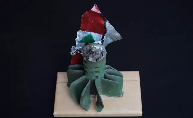 An artwork featuring the Lebanese flag, created by visual artist Lina Jouni from shrapnel collected from Israeli military munitions, is displayed at her home in the village of Roumin, southern Lebanon, Sunday, Oct. 25, 2026. (AP Photo/Hassan Ammar)