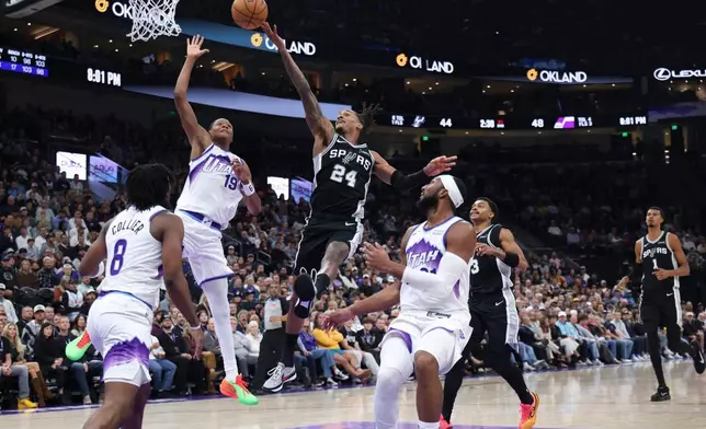 San Antonio Spurs guard Devin Vassell (24) goes for a layup against Utah Jazz guard Ace Bailey (19) during the first half of an NBA basketball game, Wednesday, Oct. 28, 2026, in Salt Lake City. (AP Photo/Rob Gray)