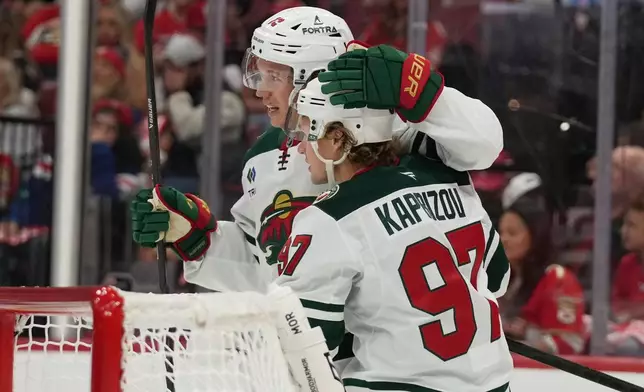 Minnesota Wild left wing Kirill Kaprizov (97) is congratulated after scoring a goal during the first period of an NHL hockey game against the Florida Panthers, Saturday, Oct. 10, 2026, in Sunrise, Fla. (AP Photo/Lynne Sladky)