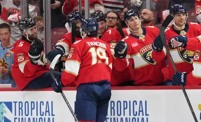 Florida Panthers left wing Matthew Tkachuk (19) is congratulated after scoring a goal during the second period of an NHL hockey game against the Minnesota Wild, Saturday, Oct. 10, 2026, in Sunrise, Fla. (AP Photo/Lynne Sladky)