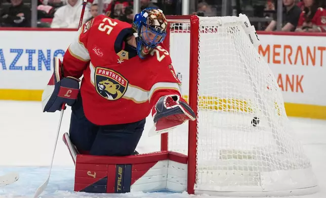 The puck gets past Florida Panthers goaltender Jacob Markstrom (25) on a goal scored by Minnesota Wild left wing Kirill Kaprizov during the first period of an NHL hockey game, Saturday, Oct. 10, 2026, in Sunrise, Fla. (AP Photo/Lynne Sladky)