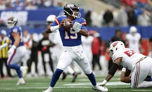 New York Giants quarterback Jameis Winston (19) avoids Arizona Cardinals defensive tackle Dante Stills, right, during an NFL football game, in East Rutherford, N.J., Sunday, Oct. 4, 2026. (AP Photo/Adam Hunger)