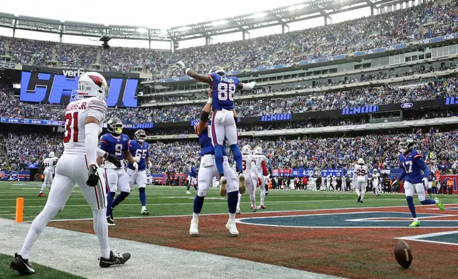 New York Giants wide receiver Malachi Fields (88) celebrates his touchdown catch against Arizona Cardinals safety Wydett Williams Jr. (31) during an NFL football game, in East Rutherford, N.J., Sunday, Oct. 4, 2026. (AP Photo/Adam Hunger)