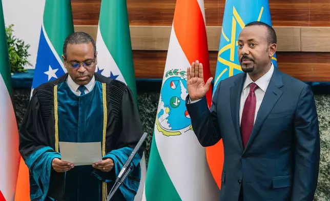 Ethiopian Prime Minister Abiy Ahmed raises his hand as he is sworn in during a session of the Ethiopian Parliament in Addis Ababa, Ethiopia, Monday, Oct. 5, 2026. (Ethiopian Prime Minster's Office via AP)