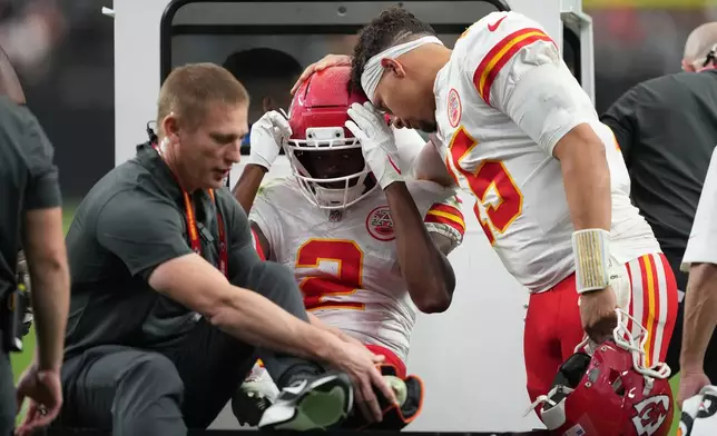 Kansas City Chiefs quarterback Patrick Mahomes (15) talks with wide receiver Tyquan Thornton (2) as he is carted off the field with an injury during the second half of an NFL football game against the Las Vegas Raiders in Las Vegas, Sunday, Oct. 4, 2026. (AP Photo/Rick Scuteri)