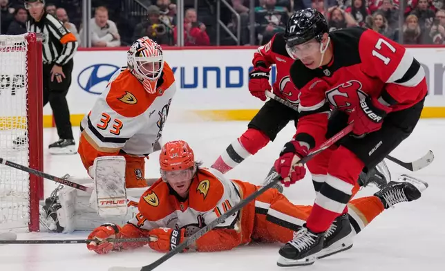 Anaheim Ducks goaltender Ville Husso, left, defends the net during the second period of an NHL hockey game against the New Jersey Devils in Newark, N.J., Thursday, Oct. 22, 2026. (AP Photo/Seth Wenig)