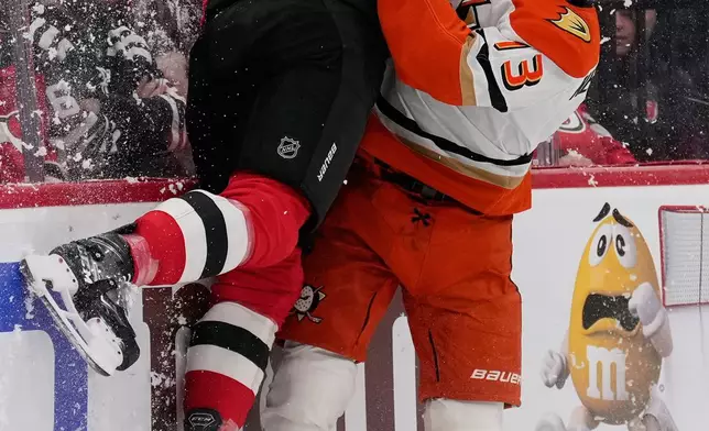 Anaheim Ducks' Nikita Nesterenko, right, and New Jersey Devils' Dougie Hamilton collide during the first period of an NHL hockey game in Newark, N.J., Thursday, Oct. 22, 2026. (AP Photo/Seth Wenig)