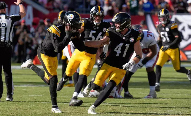 Pittsburgh Steelers cornerback Jalen Ramsey (5), left, celebrates after sacking Tampa Bay Buccaneers quarterback Jalon Daniels (10) in overtime during an NFL football game in Tampa, Fla., Sunday, Oct. 18, 2026. (AP Photo/Chris O'Meara)