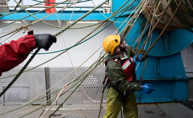 Crew members work aboard the F/V Progress in the Bering Sea off the coast of Alaska, Thursday, July 23, 2026. (AP Photo/Annika Hammerschlag)