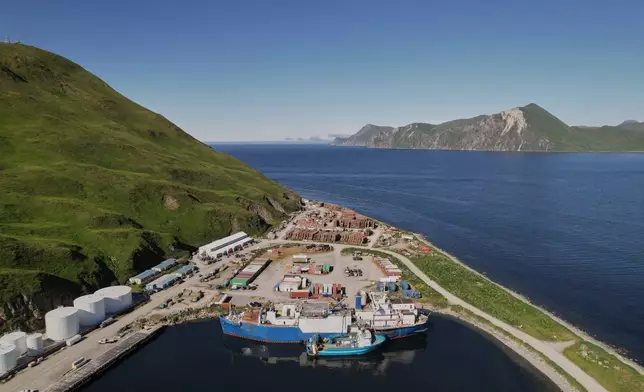 The F/V Progress delivers its catch to a processing vessel, front, in Dutch Harbor, Alaska, Friday, July 24, 2026. (AP Photo/Annika Hammerschlag)