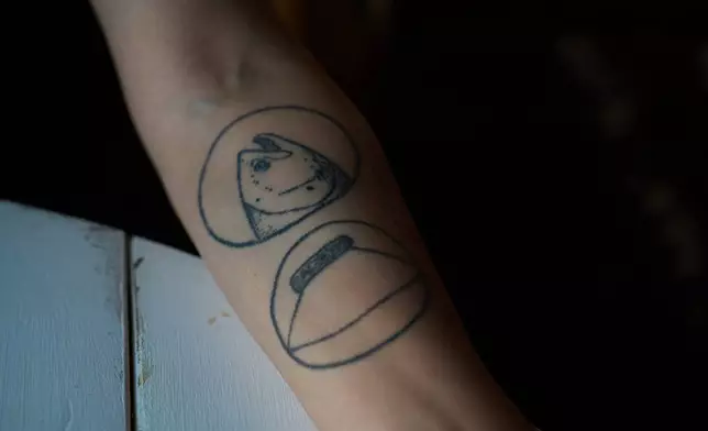 Brooke Woods shows her salmon tattoo in Rampart, Alaska, Monday, July 13, 2026. (AP Photo/Annika Hammerschlag)