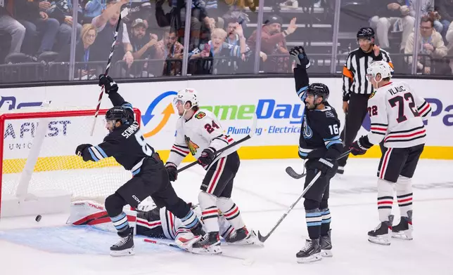 Utah Mammoth center Nick Schmaltz (8) scores against Chicago Blackhawks goalie Arvid Soderblom during second period of an NHL hockey game Thursday, Oct. 1, 2026, in Salt Lake City. (AP Photo/Melissa Majchrzak)