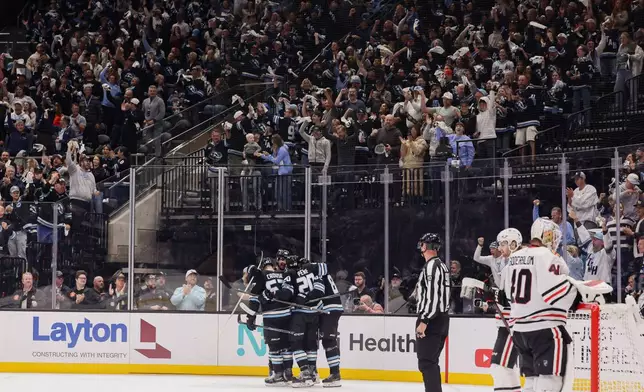 Utah Mammoth players celebrate after a goal by Utah Mammoth left wing Michael Carcone (not shown) during the first period of an NHL hockey game against the Chicago Blackhawks, Thursday, Oct. 1, 2026, in Salt Lake City. (AP Photo/Melissa Majchrzak)
