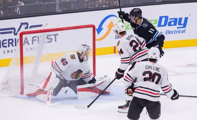 Utah Mammoth right wing Dylan Guenther (11) scores against Chicago Blackhawks goalie Arvid Soderblom (40) during the second period of an NHL hockey game Thursday, Oct. 1, 2026, in Salt Lake City. (AP Photo/Melissa Majchrzak)