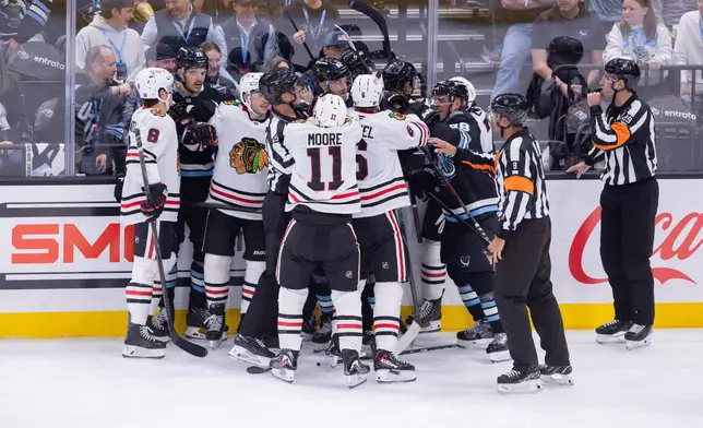 Utah Mammoth and Chicago Blackhawks players fight during the second period of an NHL hockey game Thursday, Oct. 1, 2026, in Salt Lake City. (AP Photo/Melissa Majchrzak)