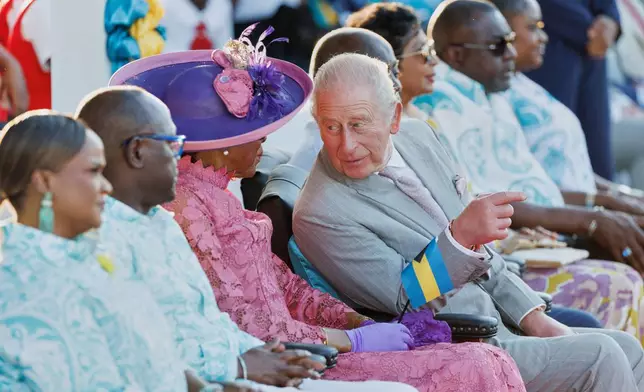 Britain's King Charles III chats with Governor General of The Bahamas Cynthia Pratt at The Future Bahamas Youth Rally and Exhibition at Clifford Park in Nassau, Bahamas, Tuesday, Oct. 27, 2026. (AP Photo/Tim Aylen)