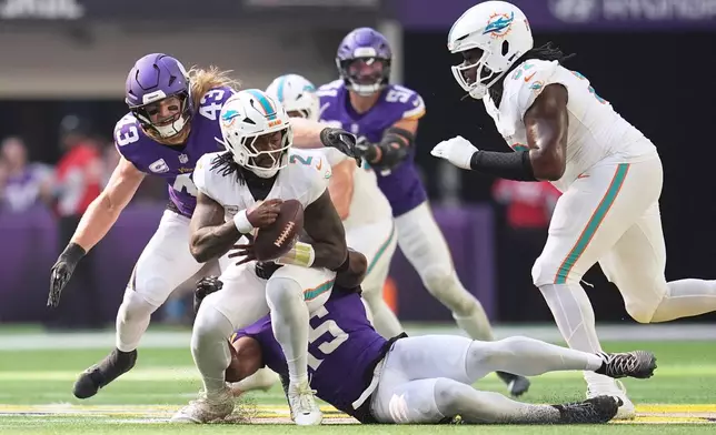 Miami Dolphins quarterback Malik Willis (2) is sacked by Minnesota Vikings linebacker Dallas Turner (15) during the first half of an NFL football game Sunday, Oct. 4, 2026, in Minneapolis. (AP Photo/Abbie Parr)