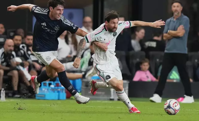 New York City FC defender Nico Cavallo, left, defends Inter Miami forward Lionel Messi, right, during the first half of an MLS soccer match, Wednesday, Oct. 14, 2026, in Miami. (AP Photo/Lynne Sladky)