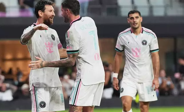 Inter Miami forward Lionel Messi, left, congratulated midfielder Rodrigo de Paul (7) after de Paul scored a goal during the first half of an MLS soccer match against New York City FC, Wednesday, Oct. 14, 2026, in Miami. (AP Photo/Lynne Sladky)