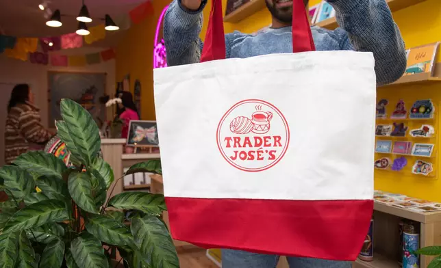 Mission Loteria CEO Luis Quiroz holds a Trader Jose's tote bag at the store on Friday, Oct. 9, 2026, in San Francisco. (AP Photo/Akash Pamarthy)